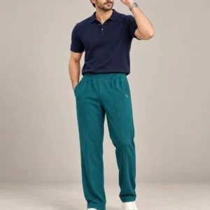 Pakistani male model wearing deep teal trousers with glasses and a wristwatch